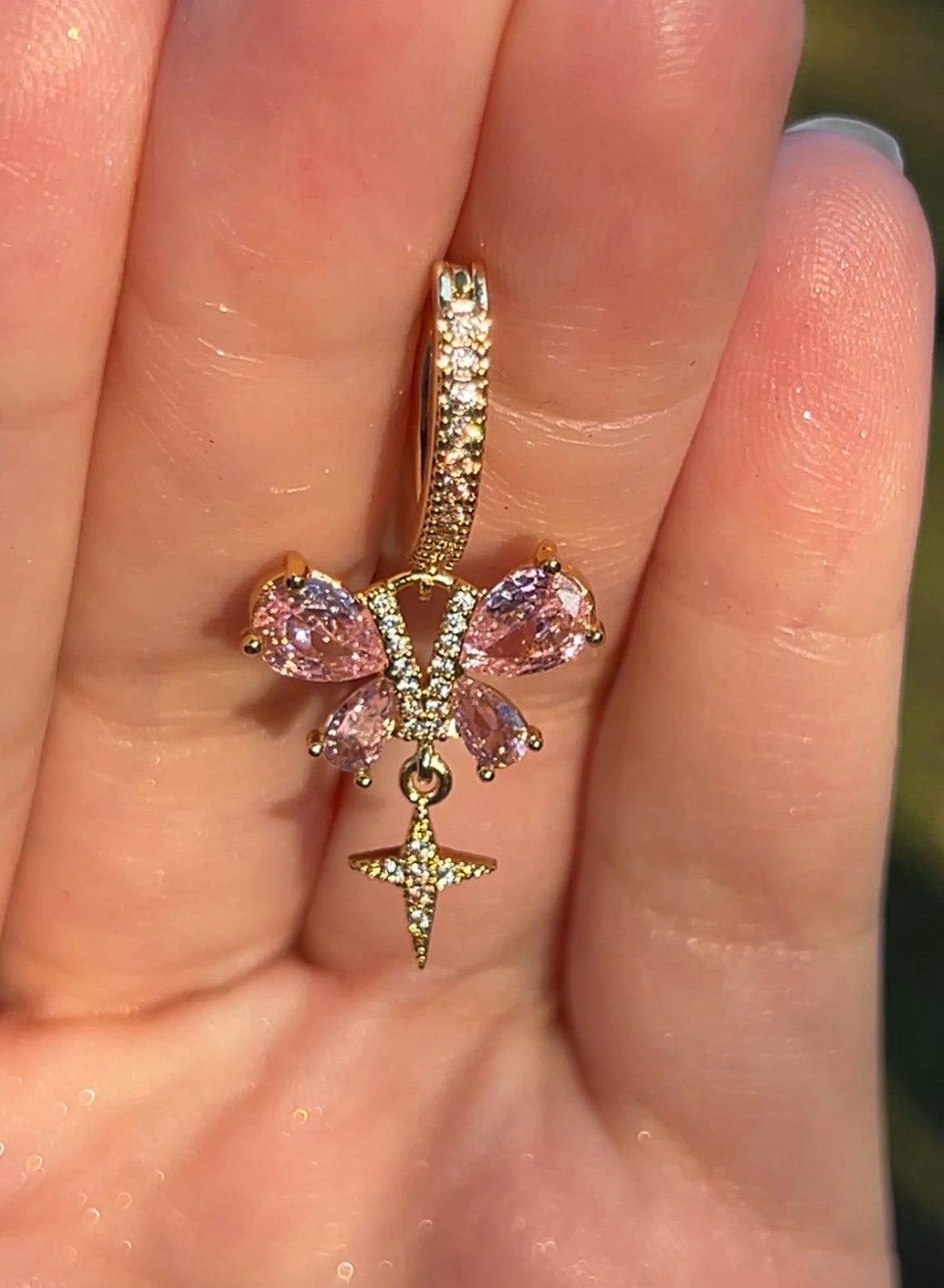 Gold butterfly clicker belly ring with pink cubic zirconia