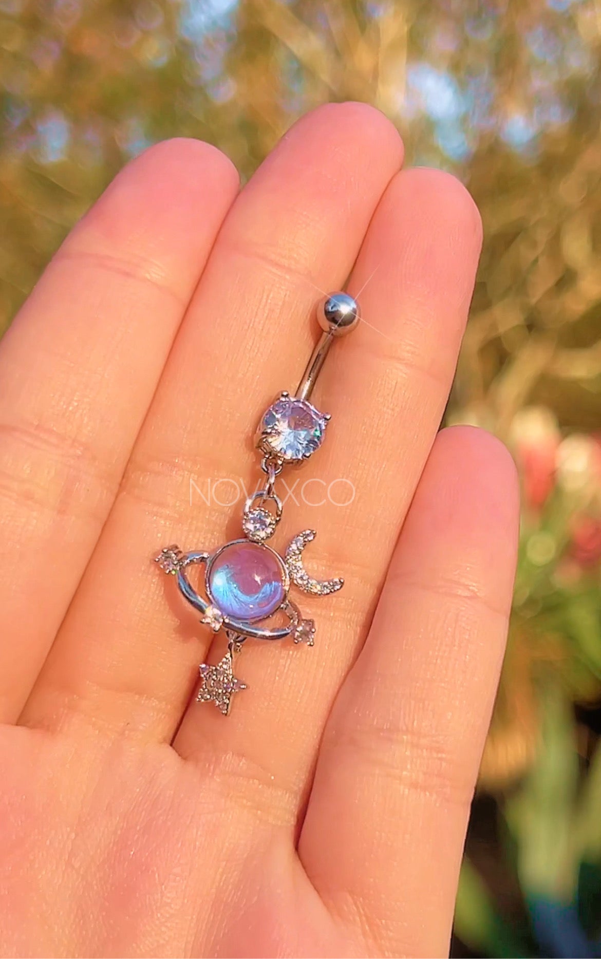 Opalescent planet dangle belly ring with star and moon charms