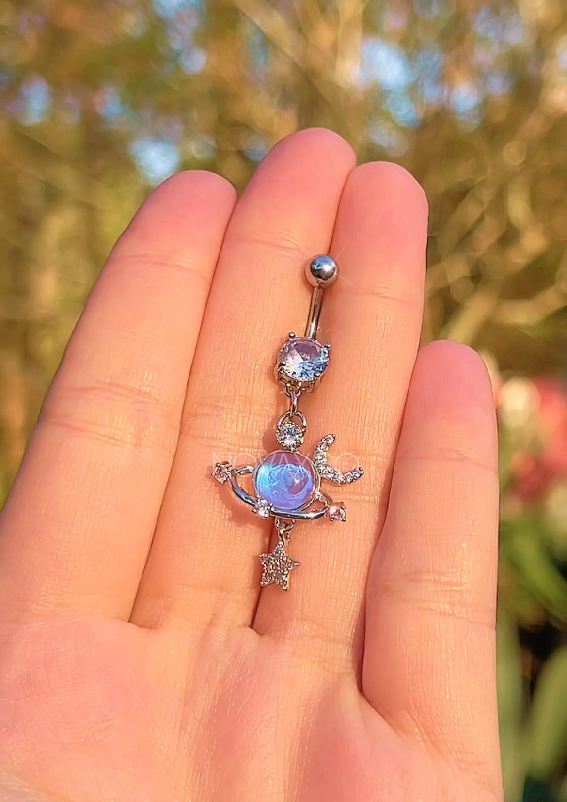 Opalescent planet dangle belly ring with star and moon charms, another view