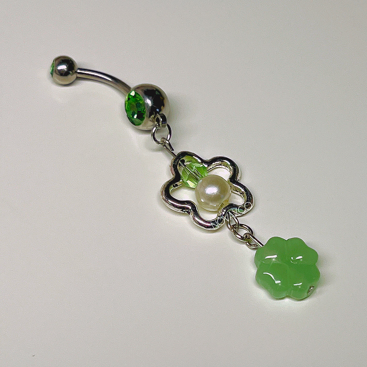 Four leaf clover lucky charm belly rings, detail view