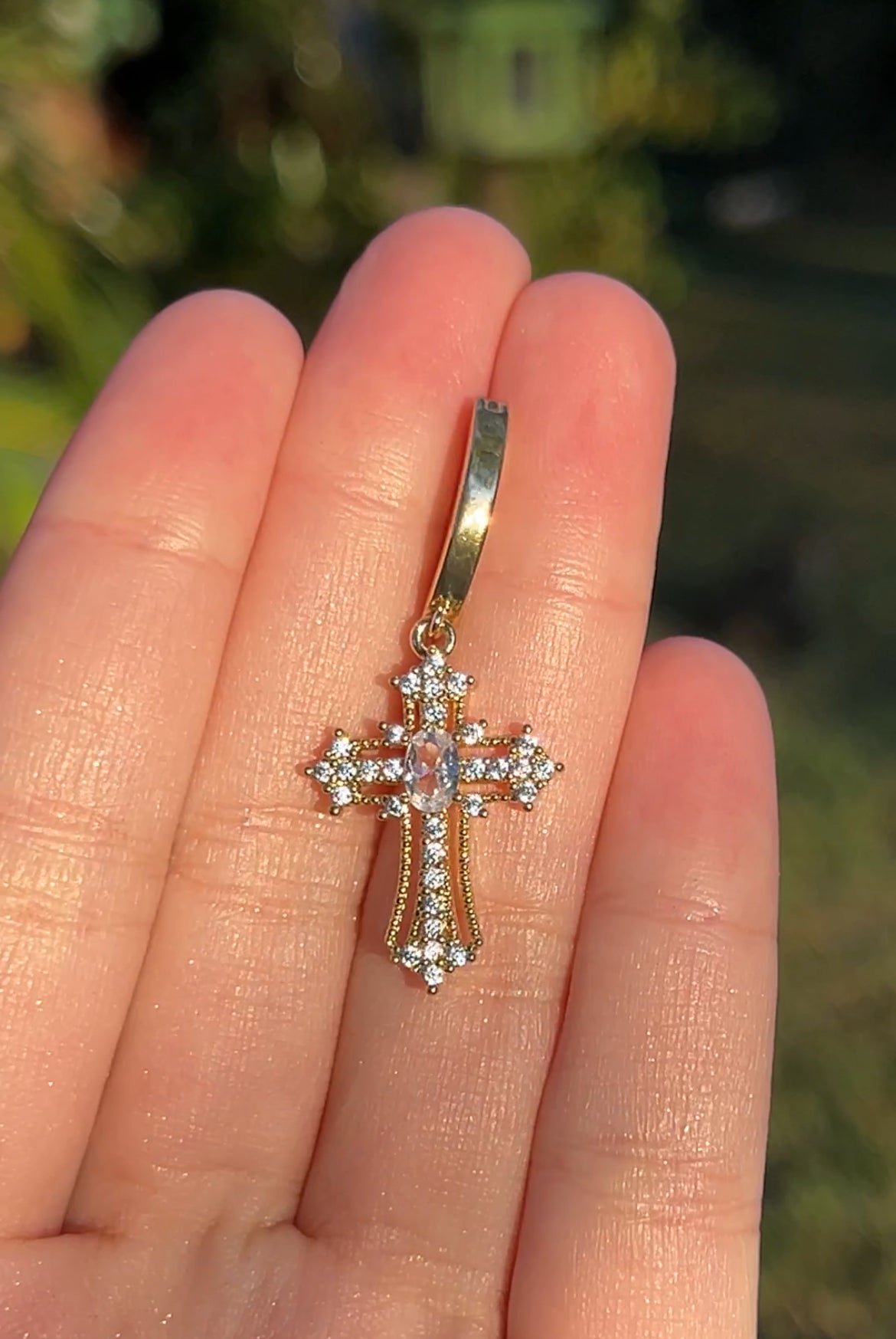 Gold cross clicker belly ring