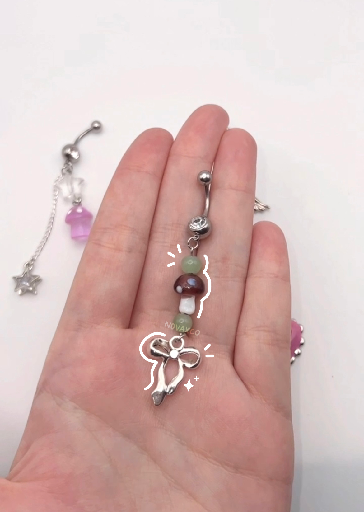 Brown earthy tone green accent belly button ring with a mushroom and bow charm 10mm 14g