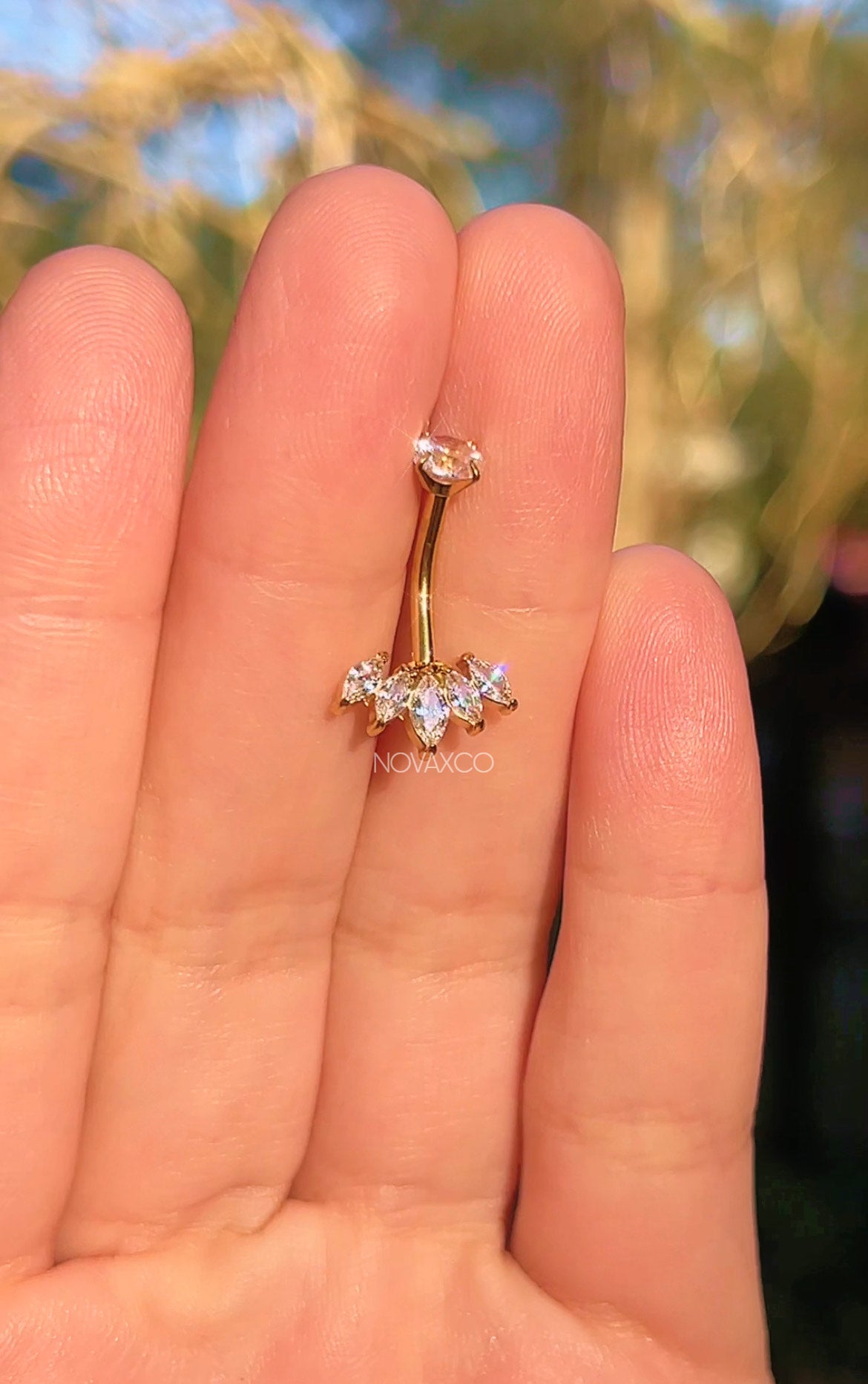 Gold lotus titanium belly button ring, detail view