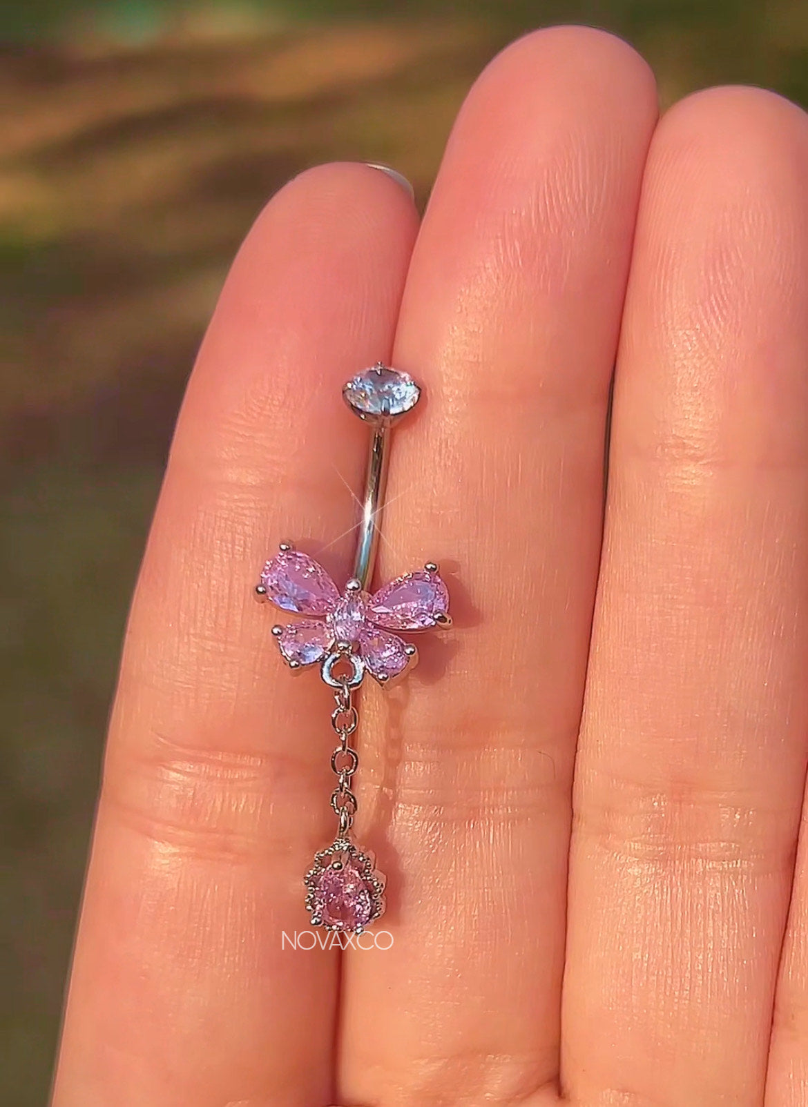 Pink butterfly titanium belly ring with a teardrop dangle