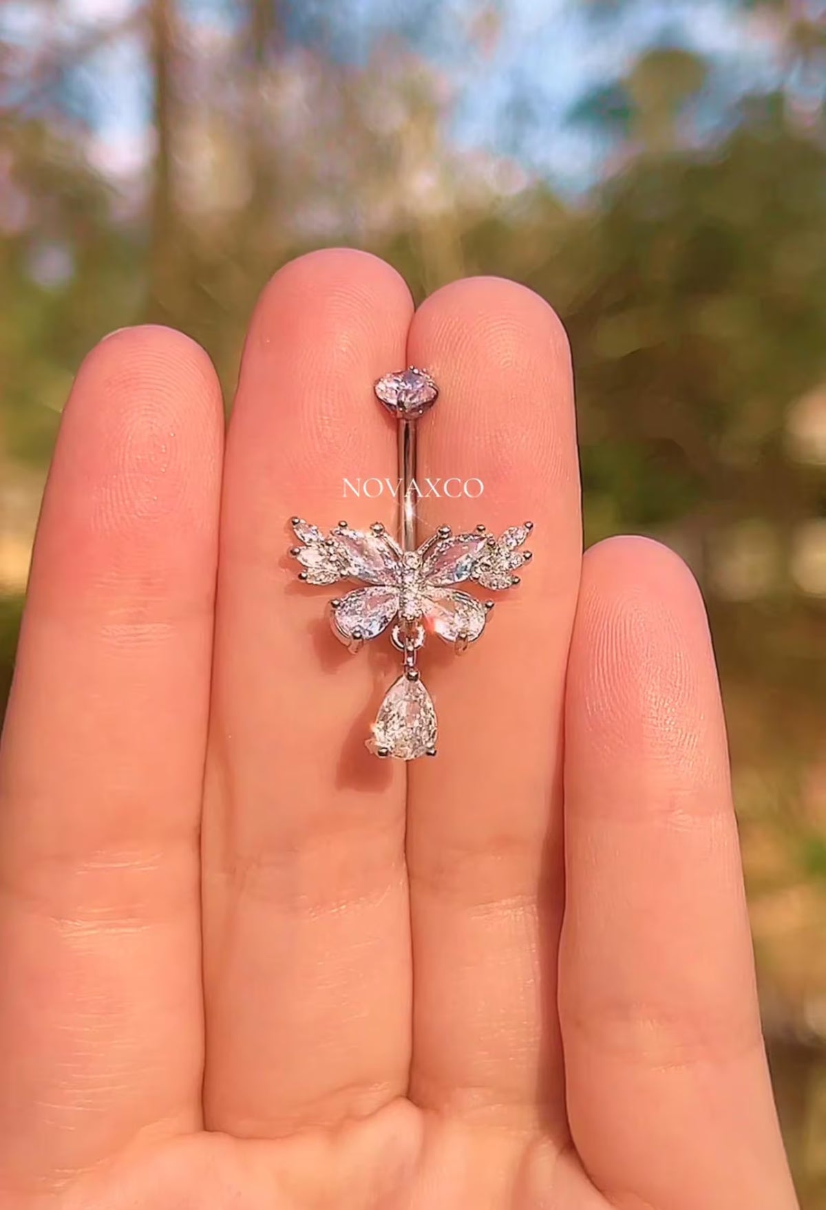Titanium butterfly belly ring with a teardrop dangle