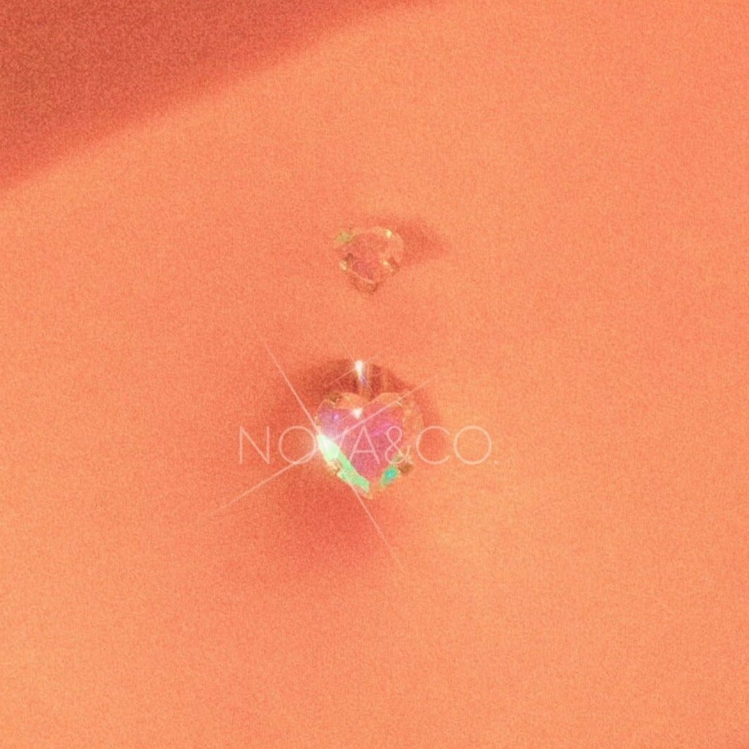 close up of belly with opalescent double heart belly ring