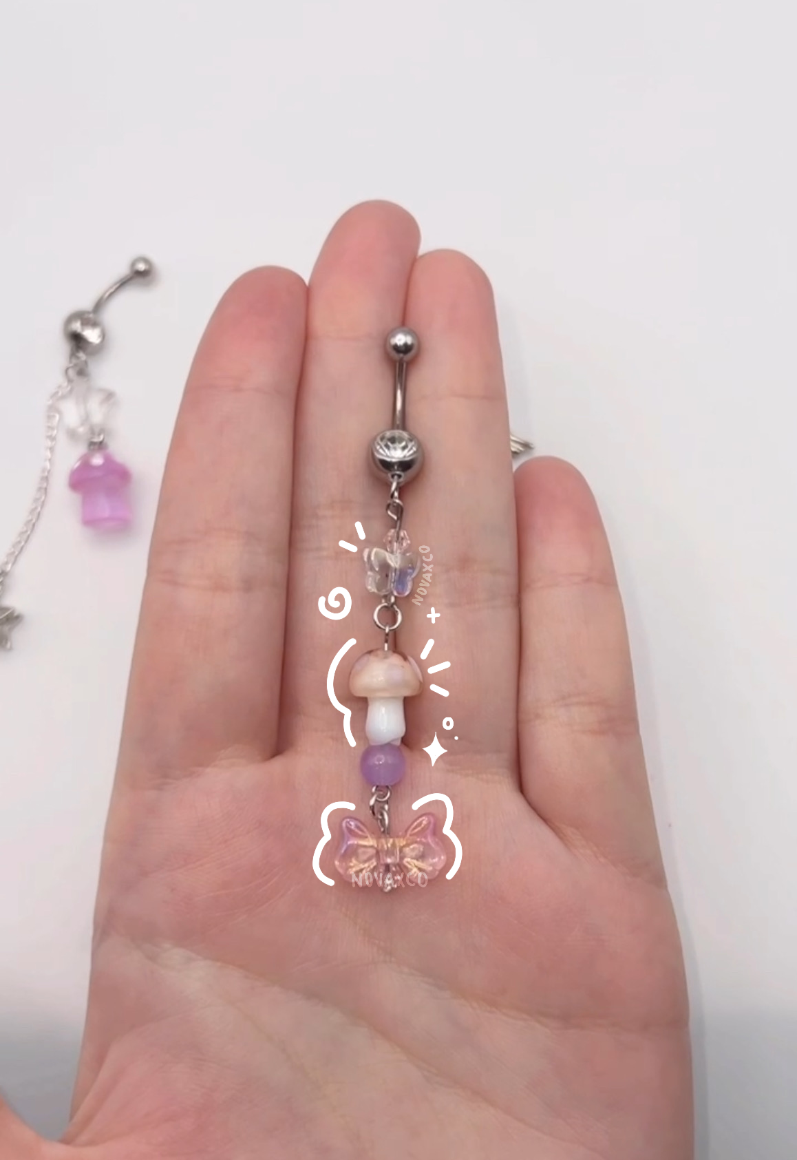 Iridescent opal mushroom dangle belly ring with a butterfly, bow and mushroom charm 10mm 14g