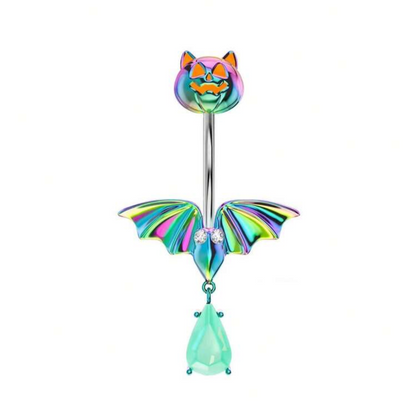 Iridescent halloween belly button ring featuring a bat with a green gemstone dangle and a pumpkin with cat ears top screw.