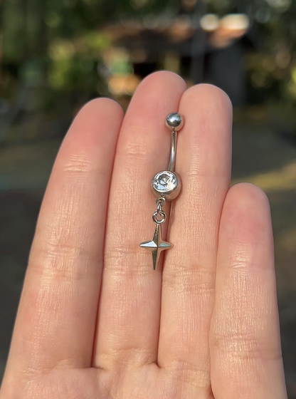Silver belly button ring with a tiny star sparkle pendant