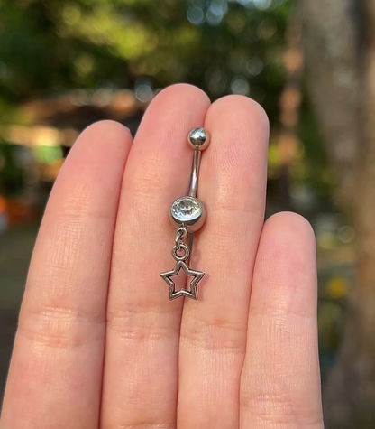 Silver belly button ring with a tiny hollow star charm 