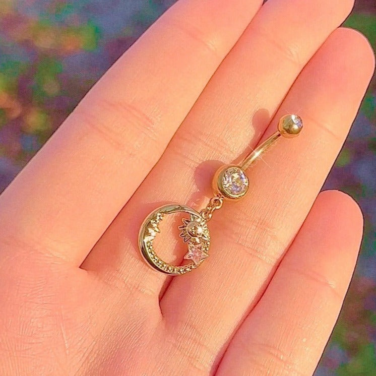 gold belly ring with moon face, sun and star